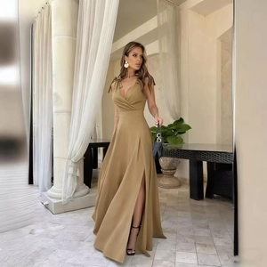 Detail of elegant V-neck long dress featuring shoulder ties and high slit hemline
