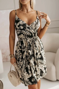 Detail of V-neck printed dress with elastic waist and tropical palm leaf pattern