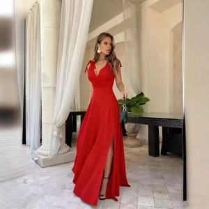 Detail of elegant dark red V-neck evening gown featuring shoulder bows and side slit