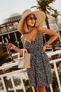 Detail of floral V-neck summer dress with waist tie and delicate white flower prints