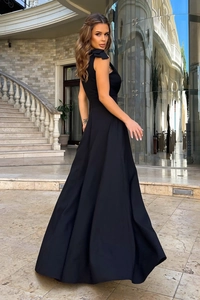 Detail of elegant shoulder bow on a black sleeveless evening gown with a satin finish