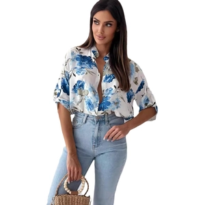 Women's summer button-up shirt with blue floral print and rolled sleeves on white base