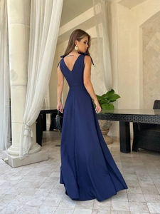Detail of dark blue maxi dress with V-neck backless design and shoulder bow ties