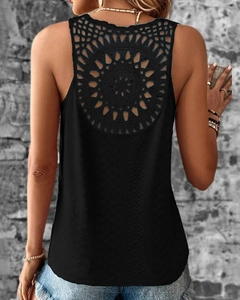 Close-up of intricate circular lace hollow-out design on the back of a black tank top