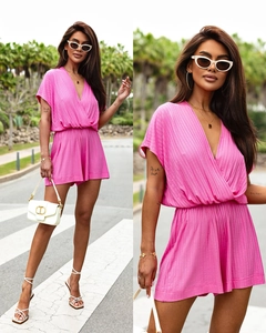 Close-up of pink ribbed knit fabric texture on a casual V-neck women's short romper