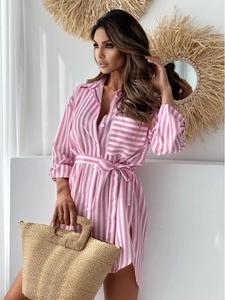 Detail of pink and white striped shirt dress featuring side slits and a matching waist belt