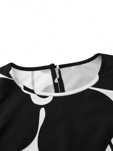 Detail of round neckline with back zipper and black floral print on the dress