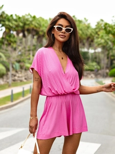 Close-up of pink V-neck ribbed knit romper featuring a stylish cross-wrap design and elastic waist