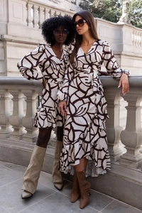 Detailed view of women's V-neck long sleeve dresses with brown abstract print and belt