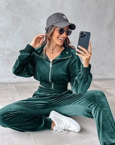 Detailed macro view of dark green velvet zip-up jacket and matching joggers texture