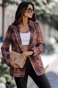 Detail shot of a women's plaid blazer featuring vibrant red patterns and notch lapels