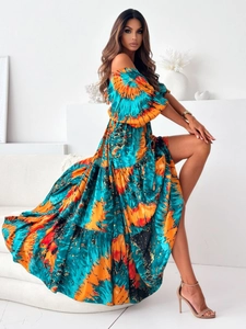 Detail of colorful abstract print and tiered layers on a boho off-shoulder maxi dress