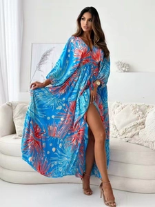 Detail of blue floral dress with V-neckline and lightweight chiffon ruffled split hem