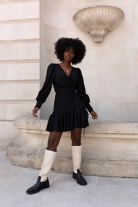 Detail view of the elegant V-neck wrap dress featuring tiered ruffle hem and puff sleeves