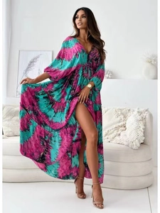 Detail of deep V-neck tie-dye maxi dress featuring side slit and lantern sleeve design