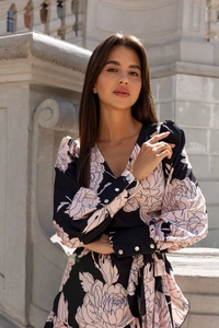 Detail of floral V-neck dress featuring puff sleeves and elegant pearly button cuffs