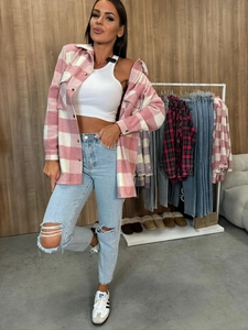 Detail of pink plaid flannel shirt paired with white crop top and ripped jeans