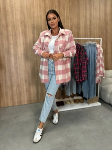 Detail of pink plaid button-down jacket with textured fabric and classic flap pockets