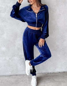 Detailed macro view of navy blue velvet two-piece track suit with ribbed cuffs and metallic zipper