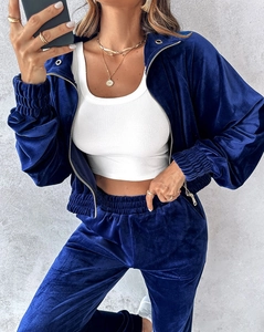 Detailed texture of navy blue velvet leisure suit with shiny fabric and zip-up jacket