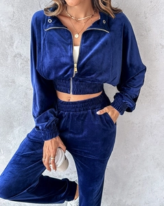 Detail of dark blue velvet tracksuit with gold metal zipper and ribbed elastic cuffs