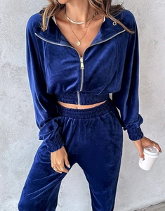 Detail of navy velvet track suit featuring high-quality gold zipper and soft texture