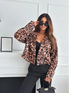 Close-up of leopard print texture and single button detail on a short blazer jacket