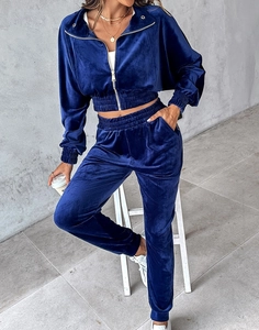 Detail of navy blue velvet tracksuit set showing soft metallic sheen and ribbed cuffs