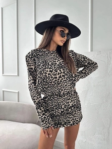 Close-up of leopard print dress featuring padded shoulders and slim fit long sleeves