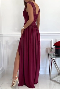Detail of burgundy maxi dress featuring intricate lace back and high side leg slit