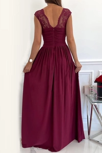 Close-up of the backless design with intricate lace embroidery on this burgundy evening gown
