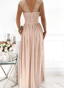 Detail view of champagne evening gown featuring floral lace stitching on the back