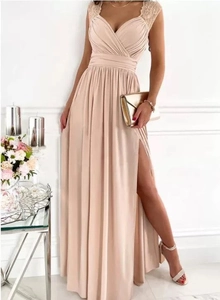 Detailed view of champagne evening gown with pleated bodice, lace straps and thigh-high slit