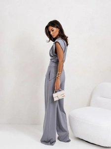 Detailed view of high-waist grey wide-leg jumpsuit with pleated sleeveless shoulder pads
