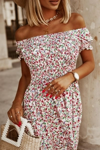 Detail of off-shoulder floral dress featuring elastic ruffled neck and sleeve design
