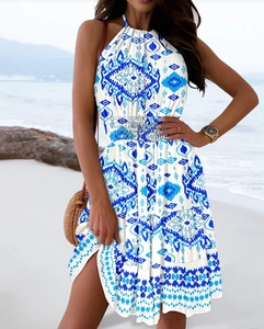 Detail of bohemian halter neck dress with blue and white floral prints and tiered skirt