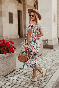 Detail of smocked off-shoulder neckline and pink floral print on light blue summer dress