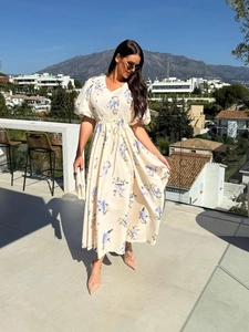 Close-up of V-neck floral maxi dress with drawstring waist and puff sleeves