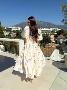Elegant low back detail of floral midi dress with puff sleeves and tie-back design