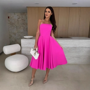 Elegant hot pink strapless midi dress for women featuring a cinched waist and flared hem