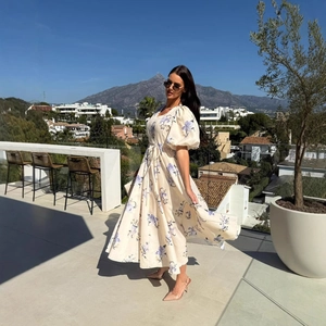 Floral V-neck puff sleeve maxi dress with drawstring waist in a scenic outdoor setting