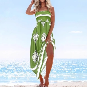 Green bohemian summer maxi dress with floral print and smocked bodice on beach