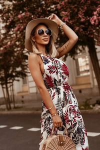 Close-up of tropical floral print on a summer halter maxi dress with tied waist belt