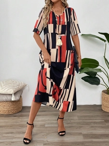 Detail of red and black geometric print fabric on summer short sleeve maxi dress