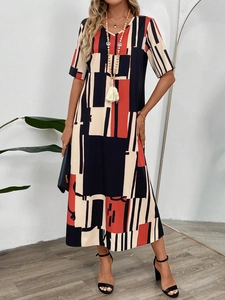 Detail of V-neck printed dress with geometric color blocks and a loose silhouette