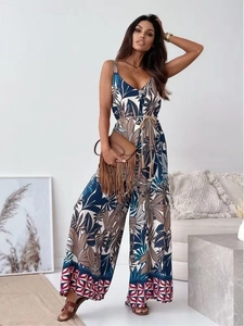 Floral V-neck wide-leg jumpsuit with tropical leaf patterns and matching waist belt
