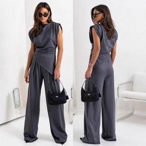 Women's dark gray two-piece set featuring asymmetrical sleeveless top and wide-leg trousers
