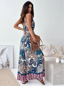 Detail of bohemian floral print and geometric hem on navy maxi jumpsuit with belt