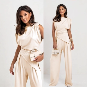 Elegant beige two-piece set featuring high-neck draped top and high-waisted wide-leg trousers