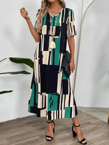 Close-up of a V-neck printed dress with geometric patchwork pattern and long A-line skirt